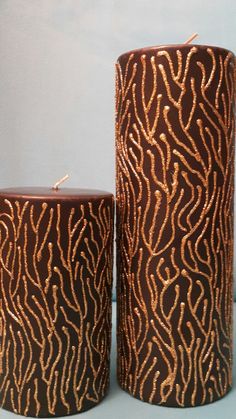 two brown candles sitting next to each other on a table