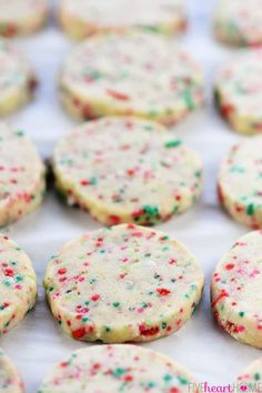 many cookies with sprinkles are on the table