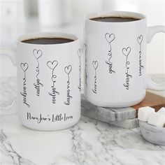 two coffee mugs sitting on top of a marble counter