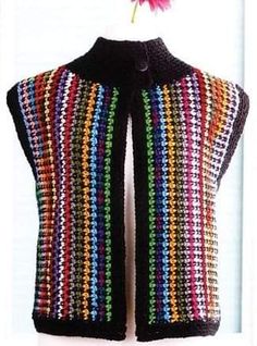 a crocheted vest with a flower on the front and back, in multicolors