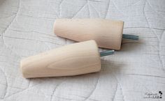 two wooden pegs laying on top of a bed