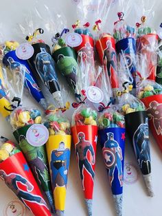 many different colored plastic cones with cartoon characters on them and wrapped in cellophane