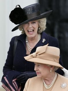 two women wearing hats and gloves are smiling