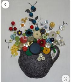 a vase filled with lots of different colored buttons