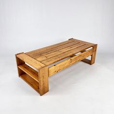 a wooden coffee table sitting on top of a white floor