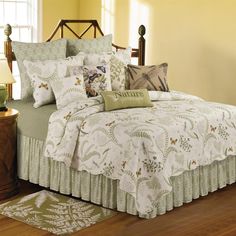 a bed sitting in a bedroom on top of a wooden floor next to a window