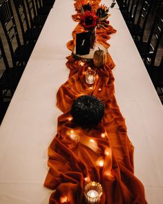 a long table with candles and flowers on it is set up for a formal function