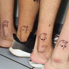 four people with matching tattoos on their feet