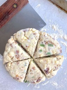 a pizza sitting on top of a cutting board next to a knife