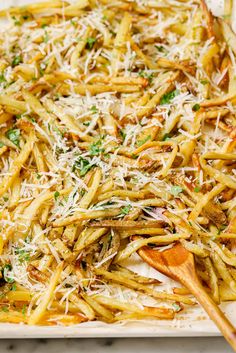 a white plate topped with french fries covered in parmesan cheese