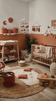 a baby's room with an orange accent wall and wooden furniture, including a crib