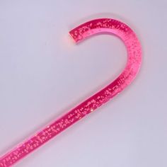 a pink handle on a white surface with small speckles and dots in it