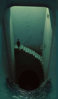 the man is walking down the stairs in the dark water to get out of the tunnel