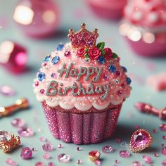 a pink cupcake with a tiara on top surrounded by jewels and confetti