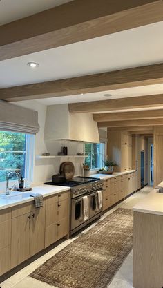 a kitchen with an oven, sink, and counter top in the middle of it