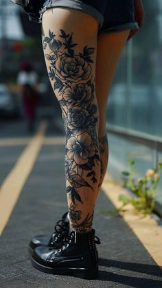 a woman's legs with tattoos and flowers on them