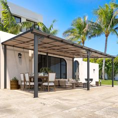 a patio covered in furniture and palm trees