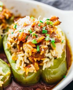 stuffed bell peppers with meat and rice in a white casserole dish