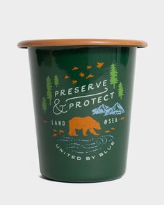 a green cup with a brown lid and bear on the side that says preserve & protect land by sea