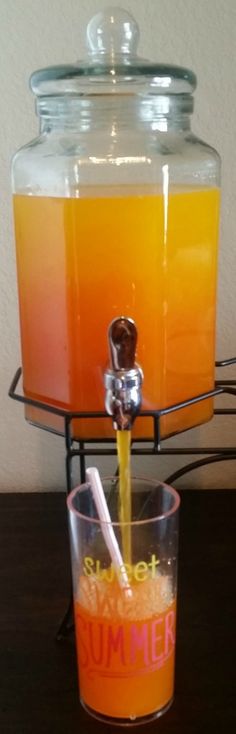 a beverage dispenser filled with orange juice