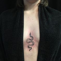 a woman with a snake tattoo on her chest