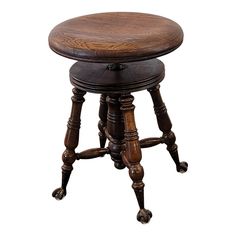 an old wooden stool with turned legs and foot rests against a white background for the image