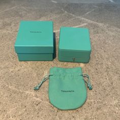 two tiffany co jewelry boxes on a counter top with one open and the other closed