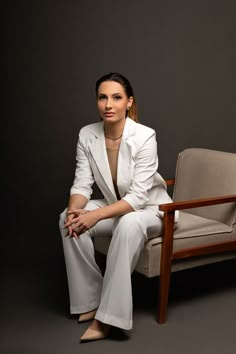 a woman sitting on top of a wooden chair