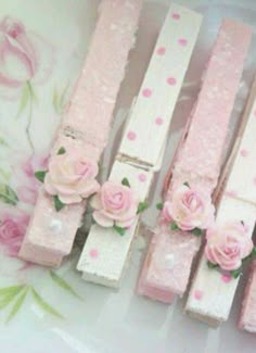 some pink flowers are sitting in the middle of wooden planks that have been made to look like roses