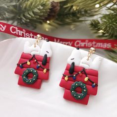 two christmas decorations are hanging from a tree