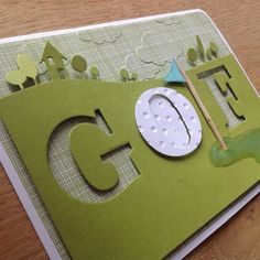 a close up of a greeting card made with the word golf on it and an image of a golf ball