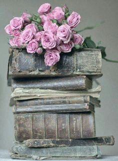 a stack of old books with pink roses on top and the quote education is what remains after you have forgotten everything you learned at school