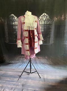 This is the whole 1770s  mens outfit.  There is the  tailcoat , a waistcoat, trousers , shirt and cravat.  The trousers are the shorter style , finishing below the knee, they have a fly and button with belt loops. The waistcoat has a lot of detailing, it in the longer style made from a thick brown gold pattern jacquard edged in a red trim with gold filigree buttons. The jacket it fully lined and has some weight to it. Made from a lilac faux brushed suede fabric and edged in gold trim. This jacke Frock Coat, Fashion Male, Lace Cuffs, Lingerie For Men, Suede Fabric, Gold Filigree, Gold Pattern, Long Style