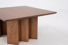 a wooden table sitting on top of a white floor