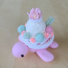 there is a small toy turtle with flowers on it