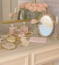 there is a vanity with flowers and other items on it