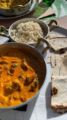 some food is sitting on a table with rice and tortillas