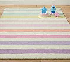 a rug with two stars and a book on the floor in front of it,