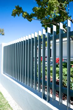 a white fence with metal bars on it