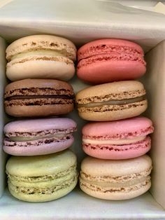 a box filled with lots of different colored macaroons