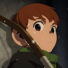 a young boy holding a bow and looking at the sky with snow falling on him