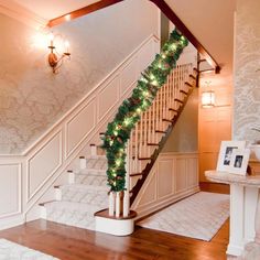 a staircase decorated with christmas garland and lights