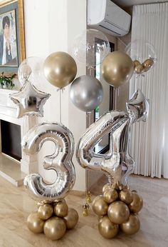 two large silver and gold balloons in the shape of numbers