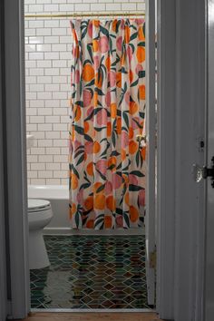 an open door leading to a bathroom with a shower curtain