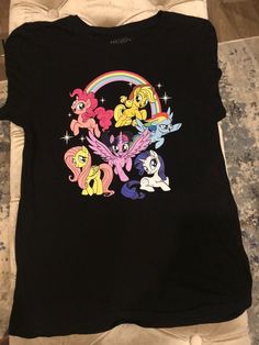 My Little Pony Shirt Shipping from the US. Easy 30 day return policy, 100% cotton, Double-needle neck, sleeves and hem; Roomy Unisex Fit. Graphic Tee With Character Print In Multicolor, Multicolor Character Print Graphic Tee, Fun Relaxed Fit Shirt With Character Print, Casual Multicolor Character Print Shirt, Trendy Relaxed Fit Shirt With Character Print, Trendy Short Sleeve Shirt With Character Print, Trendy Crew Neck Shirt With Character Print, Multicolor Graphic Tee Shirt, Casual Multicolor Character Print Tops