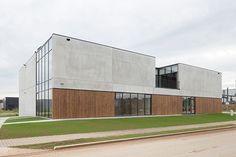 the building is made out of concrete and has wooden panels on it's sides