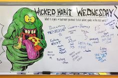 a white board with writing on it and an image of a cartoon character