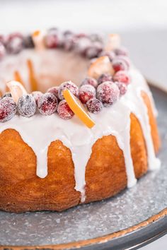 a bundt cake with icing and berries on top