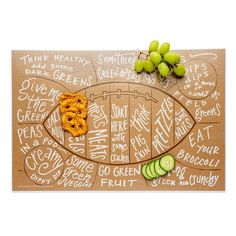 an image of a healthy food board with grapes and cucumbers on it,