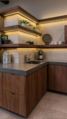 a modern kitchen with wooden cabinets and counter tops, along with a microwave oven on the wall